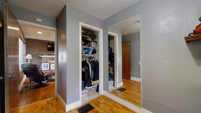 1713 Glenn Park Dr, Champaign, IL 61821 - hall with wood finished floors, a textured ceiling, and a desk