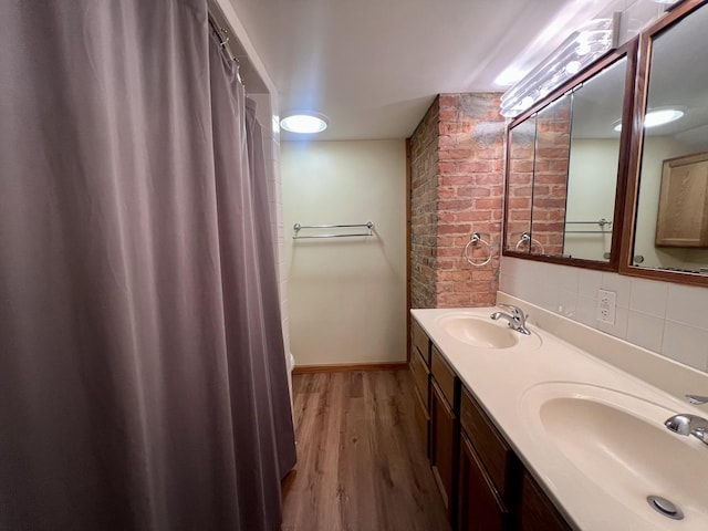 1713 Glenn Park Dr, Champaign, IL 61821 - full bath featuring wood finished floors, double vanity, and decorative backsplash