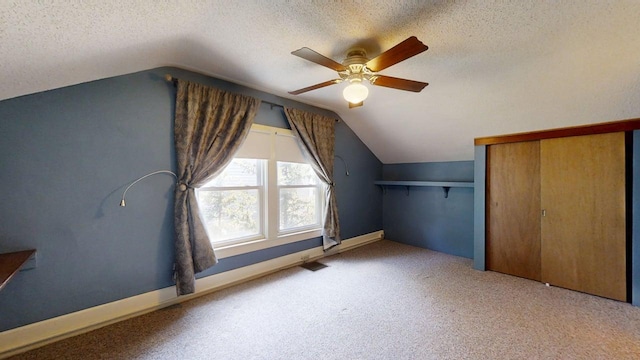 1713 Glenn Park Dr, Champaign, IL 61821 - additional living space featuring a textured ceiling, lofted ceiling, ceiling fan, and carpet