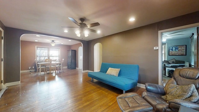 1713 Glenn Park Dr, Champaign, IL 61821 - living room featuring arched walkways, ceiling fan, light wood-style floors, and recessed lighting