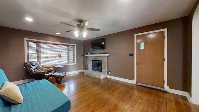 1713 Glenn Park Dr, Champaign, IL 61821 - living room featuring a ceiling fan, wood-type flooring, a brick fireplace, and recessed lighting