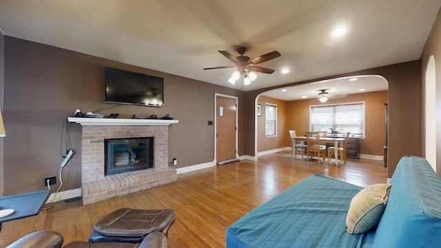 1713 Glenn Park Dr, Champaign, IL 61821 - living area featuring arched walkways, ceiling fan, hardwood / wood-style flooring, a brick fireplace, and recessed lighting