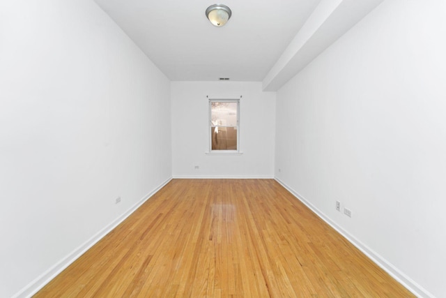 2414 W Bryn Mawr Ave Unit 1W, Chicago, IL 60659 - empty room with light wood finished floors and baseboards