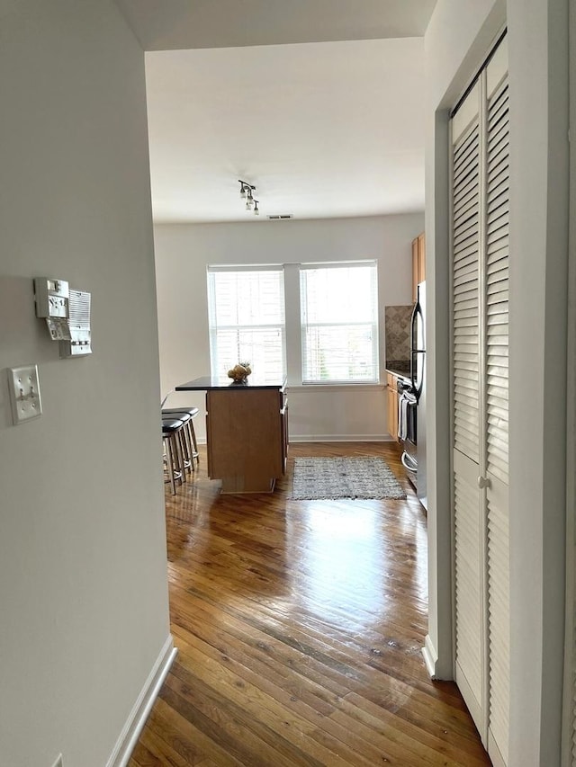 2414 W Bryn Mawr Ave Unit 1W, Chicago, IL 60659 - hallway with dark wood-type flooring and baseboards