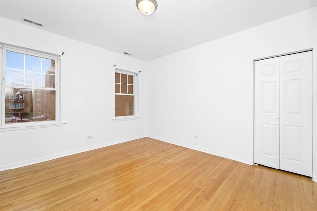 2414 W Bryn Mawr Ave Unit 1W, Chicago, IL 60659 - unfurnished bedroom featuring light wood-type flooring and a closet