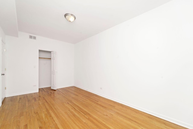 2414 W Bryn Mawr Ave Unit 1W, Chicago, IL 60659 - unfurnished bedroom featuring light wood-type flooring and a closet