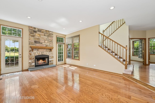 1266 Thorndale Ln, Lake Zurich, IL 60047 - unfurnished living room featuring hardwood / wood-style flooring, recessed lighting, a stone fireplace, and stairway