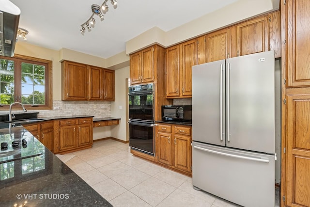 1266 Thorndale Ln, Lake Zurich, IL 60047 - kitchen featuring black appliances, brown cabinets, light tile patterned flooring, and decorative backsplash