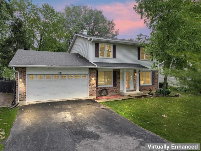 281 S Western Ave, Bartlett, IL 60103 - traditional-style house featuring driveway, an attached garage, a lawn, brick siding, and a chimney