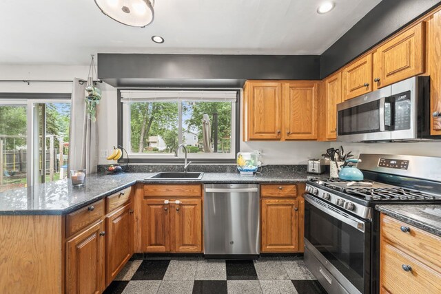281 S Western Ave, Bartlett, IL 60103 - kitchen featuring appliances with stainless steel finishes, granite tiled floors, a peninsula, recessed lighting, and brown cabinetry