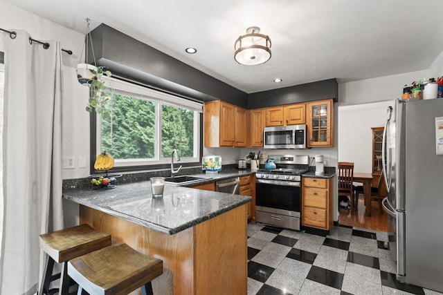 281 S Western Ave, Bartlett, IL 60103 - kitchen featuring stainless steel appliances, a peninsula, glass insert cabinets, brown cabinetry, and recessed lighting
