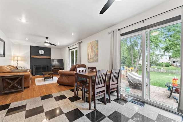 281 S Western Ave, Bartlett, IL 60103 - dining room featuring a ceiling fan, recessed lighting, healthy amount of natural light, a brick fireplace, and granite tiled floors