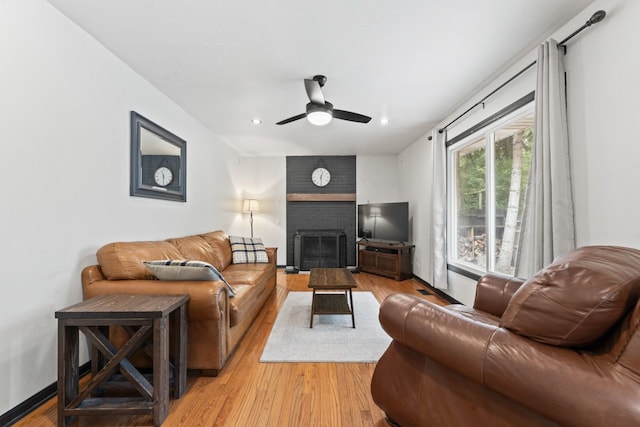 281 S Western Ave, Bartlett, IL 60103 - living area featuring light wood finished floors, a brick fireplace, ceiling fan, and recessed lighting