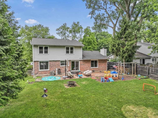 281 S Western Ave, Bartlett, IL 60103 - rear view of property with a chimney, an outdoor fire pit, a fenced backyard, brick siding, and a patio area