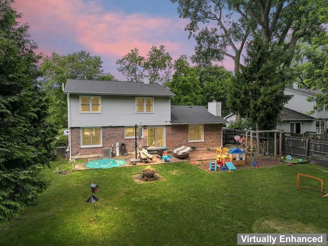 281 S Western Ave, Bartlett, IL 60103 - rear view of property featuring a chimney, a fire pit, a fenced backyard, brick siding, and a patio