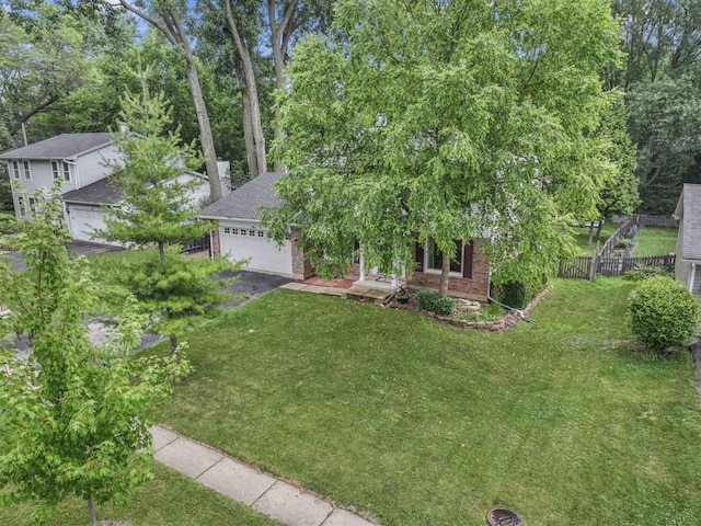 281 S Western Ave, Bartlett, IL 60103 - obstructed view of property with brick siding, a chimney, a garage, and asphalt driveway