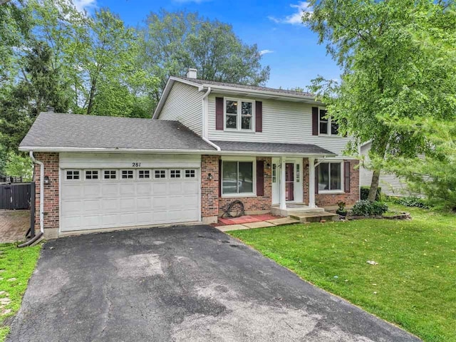 281 S Western Ave, Bartlett, IL 60103 - traditional home featuring asphalt driveway, an attached garage, brick siding, and a chimney