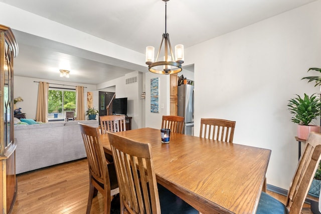 281 S Western Ave, Bartlett, IL 60103 - dining room with light wood finished floors and a chandelier