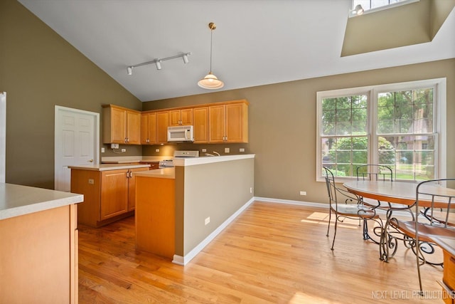 1348 Averill Cir, Geneva, IL 60134 - kitchen featuring white appliances, track lighting, light wood-style flooring, high vaulted ceiling, and a peninsula