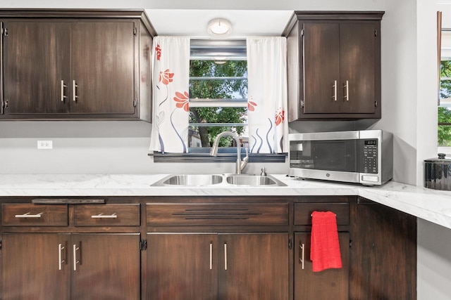 6411 W 88th St, Oak Lawn, IL 60453 - kitchen featuring stainless steel microwave, dark brown cabinetry, and healthy amount of natural light