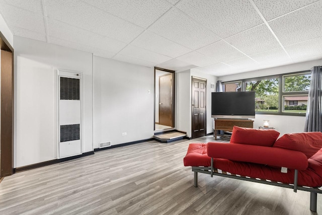 6411 W 88th St, Oak Lawn, IL 60453 - living area featuring a paneled ceiling, a heating unit, and wood finished floors