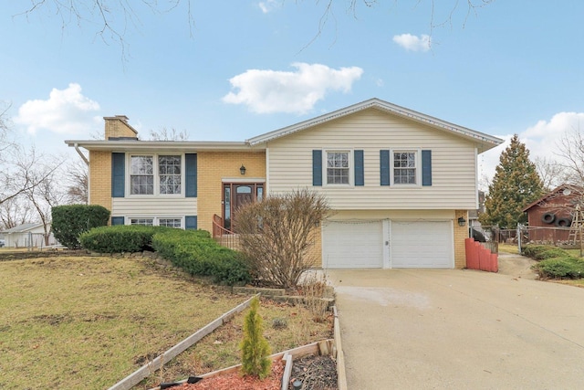 712 Dante Ct, Schaumburg, IL 60193 - bi-level home with brick siding, an attached garage, a chimney, and concrete driveway