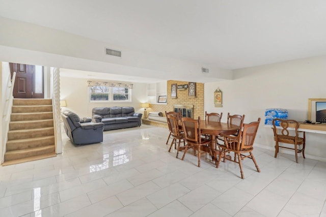 712 Dante Ct, Schaumburg, IL 60193 - dining space featuring stairway, light tile patterned floors, and a fireplace
