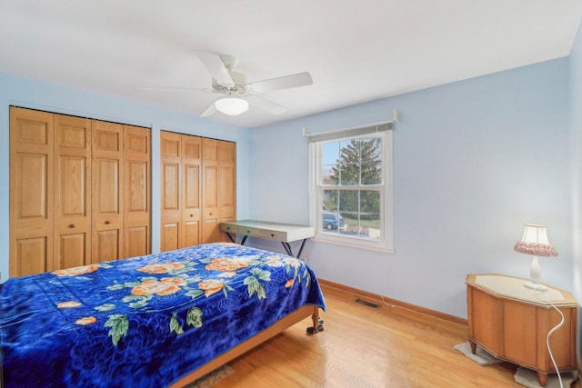 712 Dante Ct, Schaumburg, IL 60193 - bedroom featuring multiple closets, light wood-style flooring, and a ceiling fan
