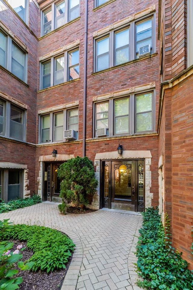 6751 N Artesian Ave Unit 2C, Chicago, IL 60645 - doorway to property featuring cooling unit and brick siding