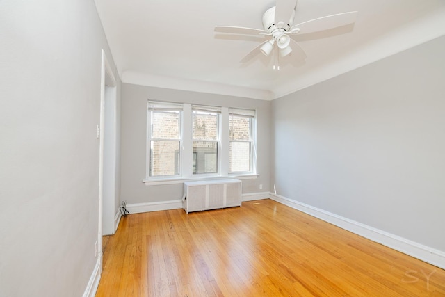6751 N Artesian Ave Unit 2C, Chicago, IL 60645 - spare room with radiator, light wood finished floors, and ceiling fan