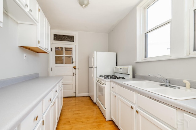 6751 N Artesian Ave Unit 2C, Chicago, IL 60645 - kitchen featuring white gas stove, light wood-type flooring, white cabinetry, and light countertops