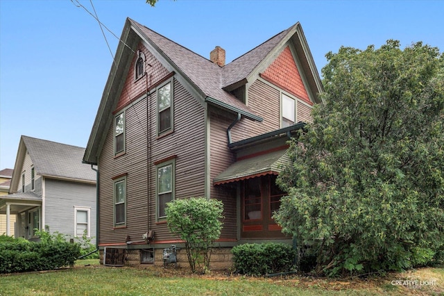 263 W Illinois Ave, Aurora, IL 60506 - back of property with a chimney, roof with shingles, and a yard