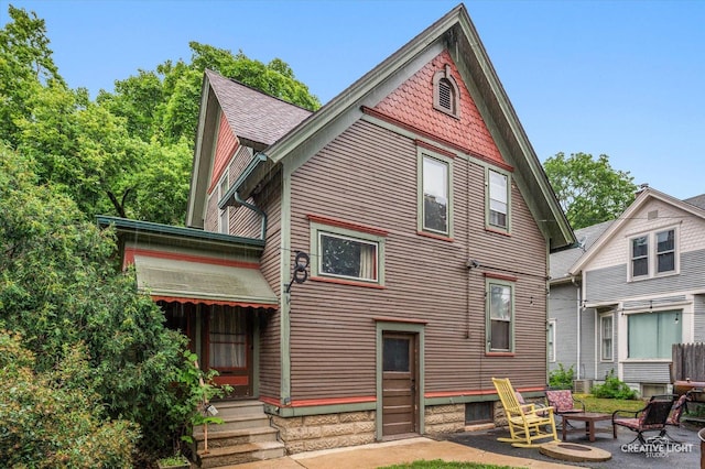 263 W Illinois Ave, Aurora, IL 60506 - rear view of house featuring entry steps, an outdoor fire pit, and a patio