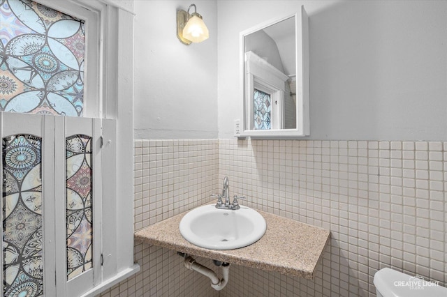 263 W Illinois Ave, Aurora, IL 60506 - half bathroom with tile walls and a wainscoted wall