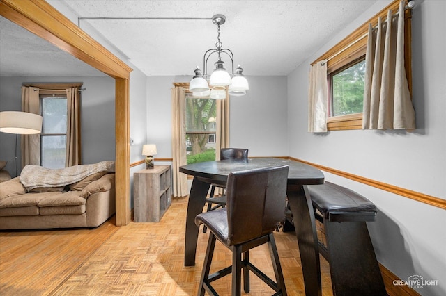 263 W Illinois Ave, Aurora, IL 60506 - dining room featuring a chandelier and a textured ceiling