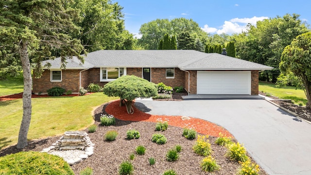 24935 S Ridge Rd, Elwood, IL 60421 - single story home with driveway, brick siding, a garage, and a front lawn