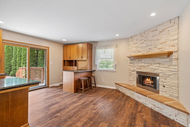 24935 S Ridge Rd, Elwood, IL 60421 - kitchen with a kitchen breakfast bar, dark wood-style floors, a fireplace, recessed lighting, and a peninsula