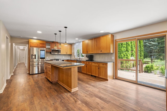 24935 S Ridge Rd, Elwood, IL 60421 - kitchen featuring stainless steel appliances, dark wood-style floors, a kitchen island, tasteful backsplash, and recessed lighting