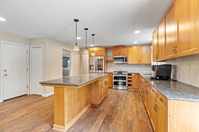 24935 S Ridge Rd, Elwood, IL 60421 - kitchen featuring appliances with stainless steel finishes, wood finished floors, a center island, decorative backsplash, and recessed lighting