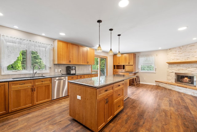 24935 S Ridge Rd, Elwood, IL 60421 - kitchen featuring stainless steel dishwasher, dark wood-style flooring, a center island, dark stone counters, and backsplash