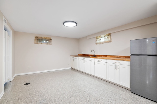 24935 S Ridge Rd, Elwood, IL 60421 - kitchen with freestanding refrigerator, butcher block countertops, white cabinets, and dark speckled floor