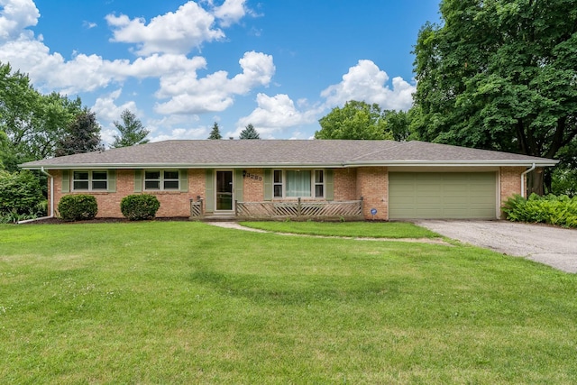 3285 Samuelson Rd, Rockford, IL 61109 - single story home with an attached garage, asphalt driveway, brick siding, and a front yard