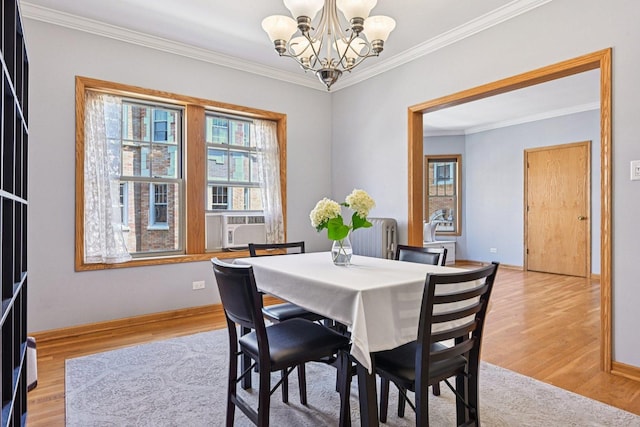 245 W Washington Blvd Unit 2B, Oak Park, IL 60302 - dining area with a chandelier, crown molding, light wood finished floors, and radiator heating unit