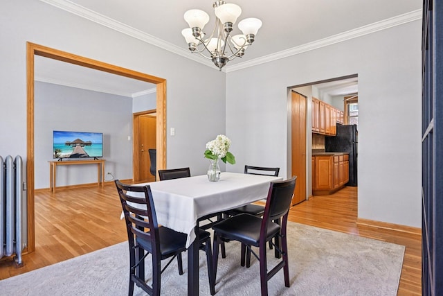 245 W Washington Blvd Unit 2B, Oak Park, IL 60302 - dining space with light wood-type flooring, a chandelier, and ornamental molding