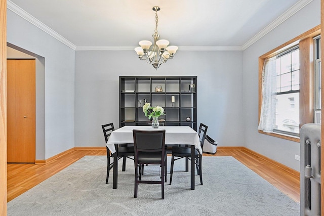 245 W Washington Blvd Unit 2B, Oak Park, IL 60302 - dining room with a chandelier, ornamental molding, wood finished floors, and radiator