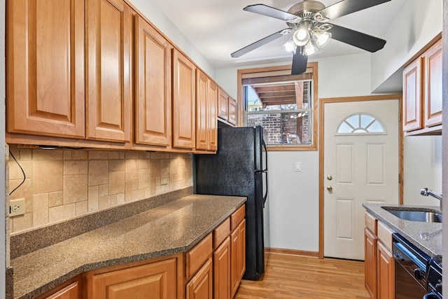 245 W Washington Blvd Unit 2B, Oak Park, IL 60302 - kitchen featuring black appliances, light wood finished floors, tasteful backsplash, ceiling fan, and dark stone counters