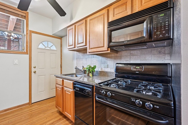 245 W Washington Blvd Unit 2B, Oak Park, IL 60302 - kitchen with black appliances, stone countertops, tasteful backsplash, light wood finished floors, and a ceiling fan