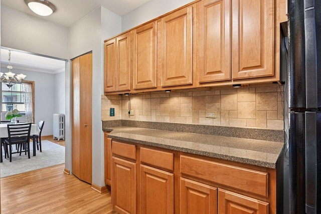 245 W Washington Blvd Unit 2B, Oak Park, IL 60302 - kitchen featuring freestanding refrigerator, radiator heating unit, light wood-style flooring, decorative backsplash, and a chandelier