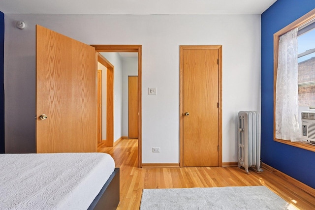 245 W Washington Blvd Unit 2B, Oak Park, IL 60302 - bedroom featuring radiator heating unit and light wood finished floors