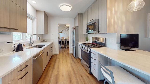 1671 N Belmont Ct, Arlington Heights, IL 60004 - kitchen featuring stainless steel appliances, modern cabinets, light wood-style flooring, light countertops, and light brown cabinetry